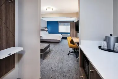 a hotel room with a bed and a desk at Holiday Inn Express Hotel & Suites Wauseon by IHG in Wauseon