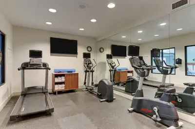 a gym with several treadmills and cardio machines at Holiday Inn Express Hotel & Suites Dayton-Centerville by IHG in Centerville