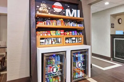 a snack bar with two refrigerators and drinks at Hampton Inn Monroe in Monroe