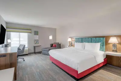 a hotel room with a bed and a television at Hampton Inn New Philadelphia in New Philadelphia
