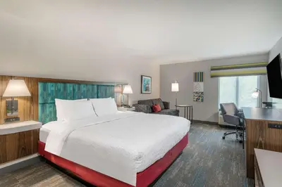 a hotel room with a bed and a desk at Hampton Inn New Philadelphia in New Philadelphia