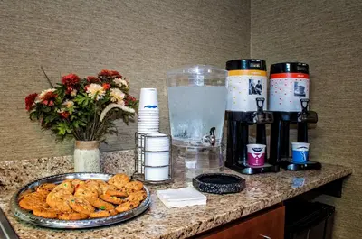 a counter with a plate of cookies and a drink at Hampton Inn New Philadelphia in New Philadelphia