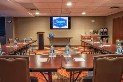 a conference room with tables and chairs with water bottles on them at Hampton Inn New Philadelphia in New Philadelphia