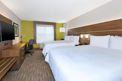 a hotel room with two beds and a flat screen tv at Holiday Inn Express & Suites Dayton South Franklin by IHG in Franklin