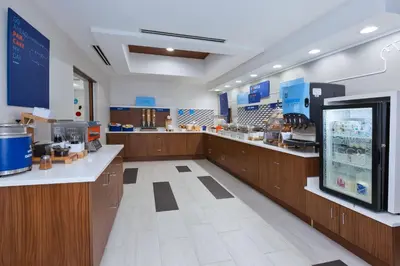 a large kitchen with wooden cabinets and a counter at Holiday Inn Express & Suites Dayton South Franklin by IHG in Franklin