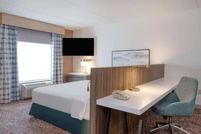 a hotel room with a bed and a desk at Hilton Garden Inn Clarksburg in Clarksburg