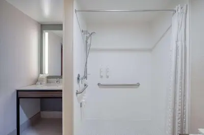 a bathroom with a shower and a sink at Hilton Garden Inn Clarksburg in Clarksburg