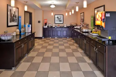 a large kitchen with counters and a cafeteria at Wingate by Wyndham Steubenville in Steubenville