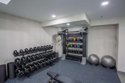 a gym with a bunch of dumbbells on the wall at Hampton Inn Springfield in Springfield