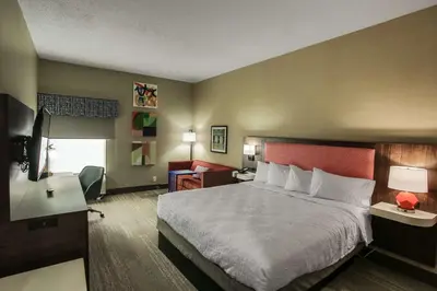 a hotel room with a bed and a desk at Hampton Inn Springfield in Springfield