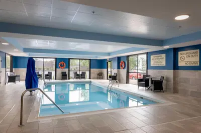 a large swimming pool in a room with blue walls at Hampton Inn Springfield in Springfield