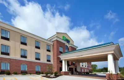 a hotel with a sign on the front of a building at Holiday Inn Express Hotel & Suites Tipp City by IHG in Tipp City