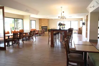 a dining room with tables and chairs in a restaurant at Country Inn & Suites by Radisson, Sandusky South, OH in Milan