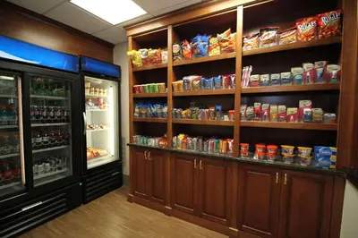 a room with a refrigerator and shelves with food at Country Inn & Suites by Radisson, Sandusky South, OH in Milan