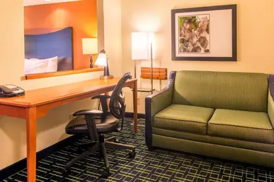 a hotel room with a desk and a chair at Fairfield Inn & Suites Canton in North Canton