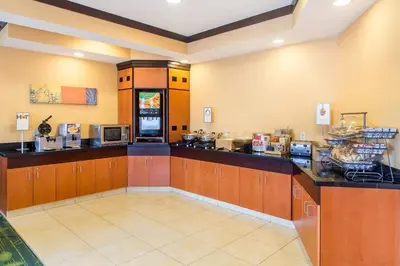 a large kitchen with a counter in a restaurant at Fairfield Inn & Suites Canton in North Canton