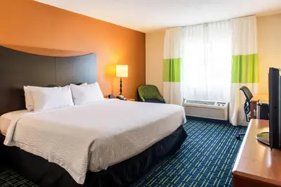 a hotel room with a bed and a window at Fairfield Inn & Suites Canton in North Canton
