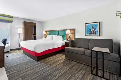 a hotel room with a bed and a couch at Hampton Inn Washington in Washington