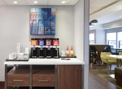 a bar with bottles on a counter in a room at Hampton Inn Youngstown/Boardman in Poland