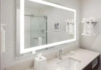 a bathroom with a sink and a large mirror at Hampton Inn Youngstown/Boardman in Poland