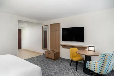 a hotel room with a bed and a table and a tv at Hampton Inn Marietta in Marietta