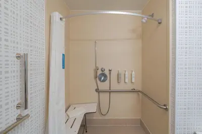 a bathroom with a shower and a sink at Hampton Inn Marietta in Marietta