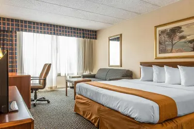 a hotel room with a bed and a desk at Quality Inn and Conference Center in Springfield