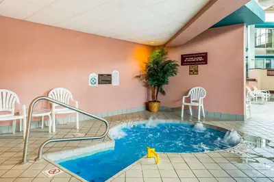 a hot tub in a waiting room with chairs and tables at Quality Inn and Conference Center in Springfield