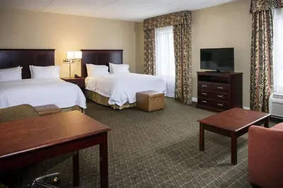 a hotel room with two beds and a flat screen tv at Hampton Inn & Suites Toledo-Perrysburg in Rossford