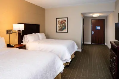 a hotel room with two beds and a flat screen tv at Hampton Inn & Suites Toledo-Perrysburg in Rossford