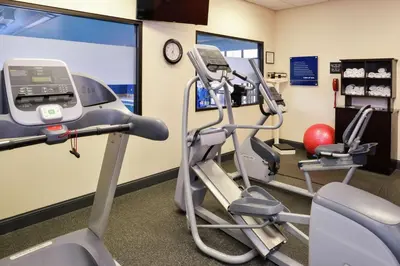 a gym with a treadmill and a elliptical machine at Hampton Inn & Suites Wilmington in Wilmington