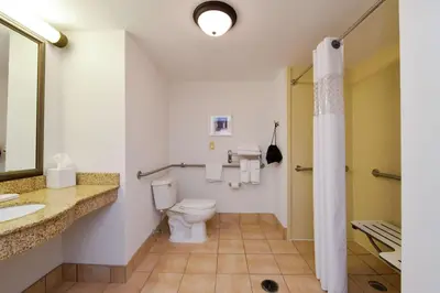 a bathroom with a toilet and a sink at Hampton Inn & Suites Wilmington in Wilmington
