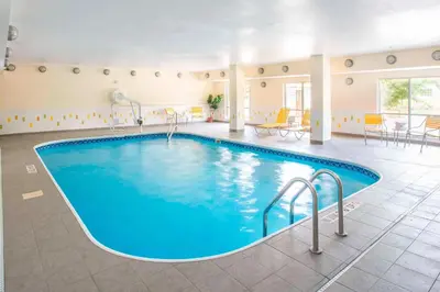 a pool in a hotel room with blue water at Fairfield Inn & Suites by Marriott Dayton South in Centerville