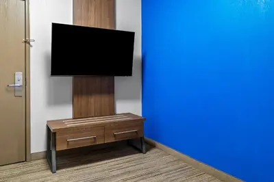 a flat screen tv on a stand in a room at Holiday Inn Express Hotel & Suites Marion by IHG in Marion