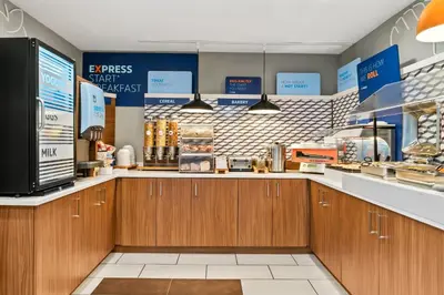 a kitchen with wooden cabinets and a counter in a store at Holiday Inn Express Hotel & Suites Marion by IHG in Marion
