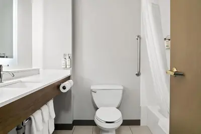 a white bathroom with a toilet and a sink at Holiday Inn Express Hotel & Suites Marion by IHG in Marion