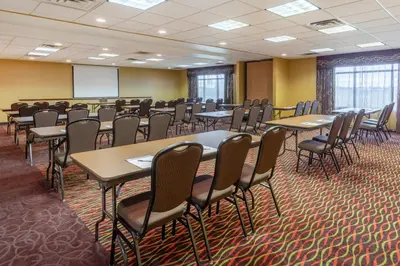 a conference room with tables and chairs and a whiteboard at Holiday Inn Express Hotel & Suites Bowling Green by IHG in Bowling Green