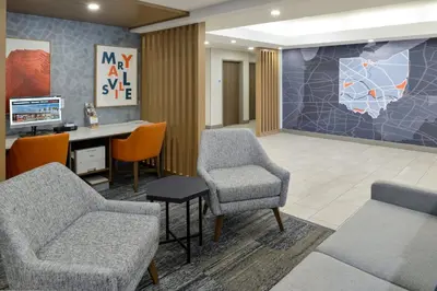 a waiting room with chairs and a desk and a computer at Holiday Inn Express Hotel and Suites Marysville by IHG in Marysville