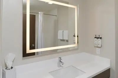 a bathroom with a sink and a mirror at Holiday Inn Express Hotel and Suites Marysville by IHG in Marysville