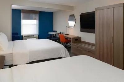 a hotel room with two beds and a desk at Holiday Inn Express Hotel and Suites Marysville by IHG in Marysville