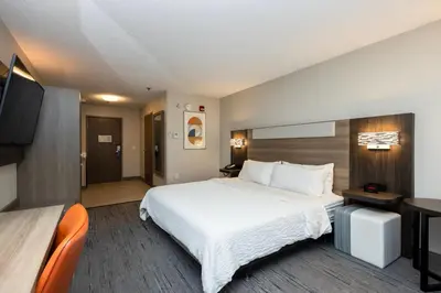 a hotel room with a bed and a flat screen tv at Holiday Inn Express Hotel and Suites Marysville by IHG in Marysville