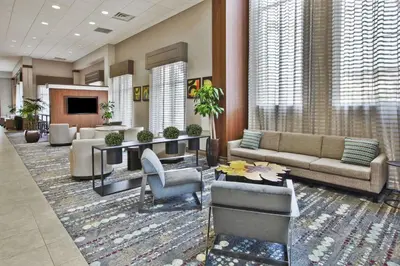 a lobby with a couch and chairs and a table at Embassy Suites Columbus - Airport in Columbus