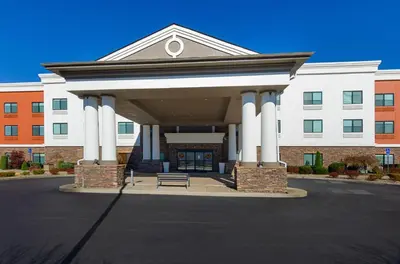 a building with a bench in front of it at Holiday Inn Express Hotel & Suites Weston by IHG in Weston