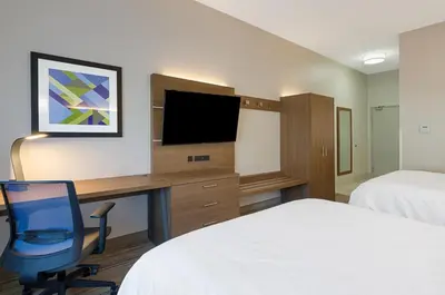 a hotel room with a desk and a tv at Holiday Inn Express Hotel & Suites Weston by IHG in Weston