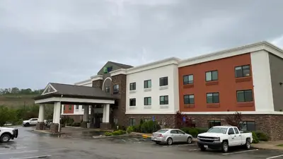 a parking lot in front of a hotel at Holiday Inn Express Hotel & Suites Weston by IHG in Weston