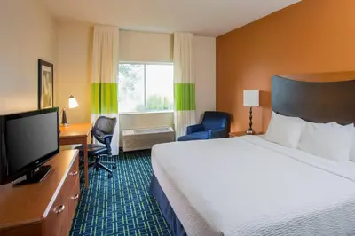 a hotel room with a bed and a desk and a television at Fairfield Inn Middletown Monroe in Middletown