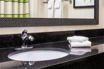 a sink in a bathroom with a mirror and towels at Fairfield Inn Middletown Monroe in Middletown