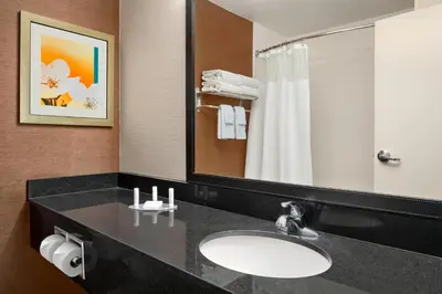 a bathroom with a sink and a mirror at Fairfield Inn & Suites Lima in Lima