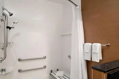 a bathroom with a shower with a shower curtain at Fairfield Inn & Suites Lima in Lima