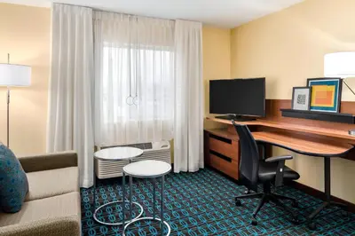 a hotel room with a desk and a computer at Fairfield Inn & Suites Lima in Lima